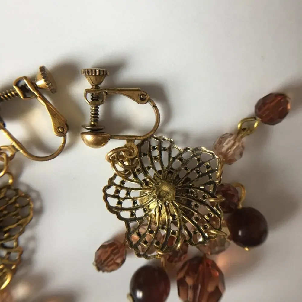 Darling ornate clip on earrings with beaded accents in amber/garnet tones